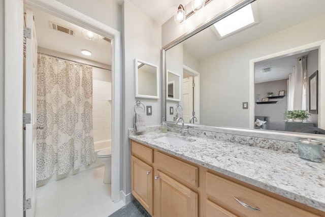 bathroom featuring visible vents, toilet, vanity, and shower / tub combo