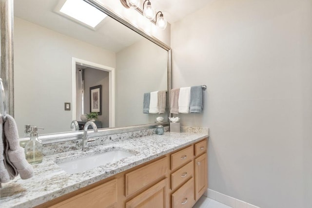 bathroom with vanity and baseboards