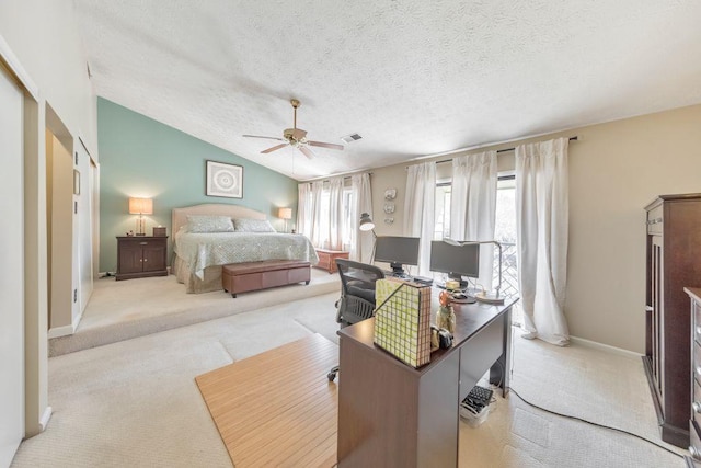 bedroom featuring a textured ceiling, lofted ceiling, visible vents, and light carpet