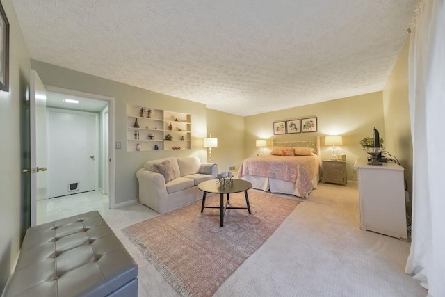 bedroom featuring baseboards, light carpet, and a textured ceiling