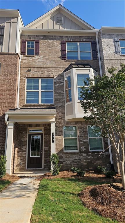 543 Fundao Ln # 26, Lawrenceville, GA 30046 - townhome / multi-family property with board and batten siding and brick siding