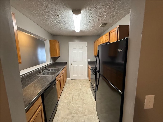 kitchen with sink, a textured ceiling, and black appliances