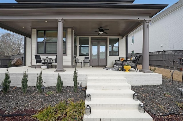 property entrance featuring covered porch and ceiling fan