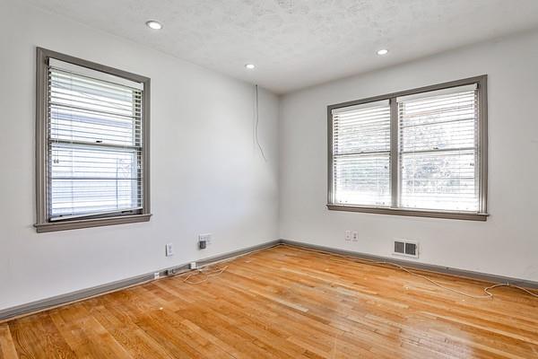 spare room with visible vents, plenty of natural light, and light wood finished floors