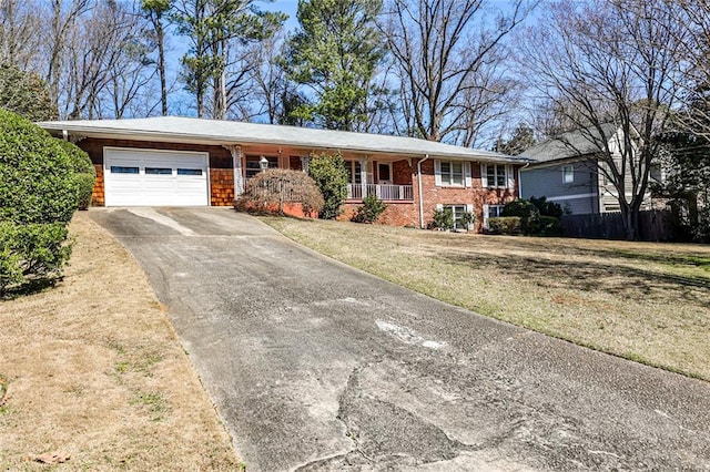 single story home featuring brick siding, concrete driveway, an attached garage, a porch, and a front yard