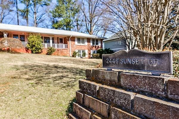 exterior space with a front lawn and brick siding