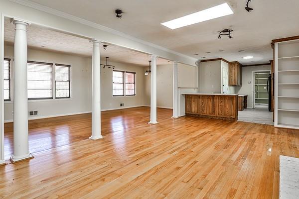 interior space with open floor plan, visible vents, and ornate columns