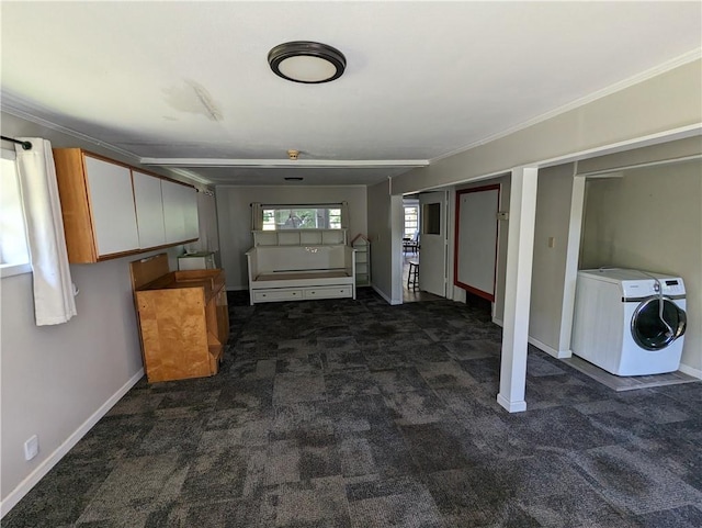 interior space with laundry area, ornamental molding, dark carpet, and baseboards