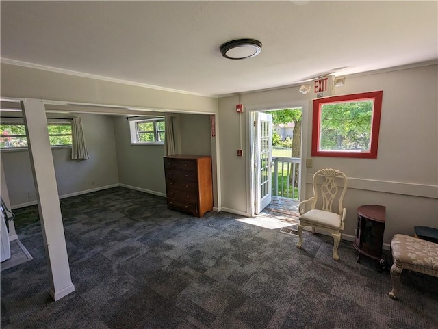 unfurnished room featuring dark carpet and baseboards