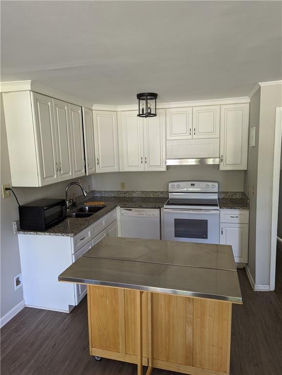 kitchen with white appliances, white cabinets, and a sink