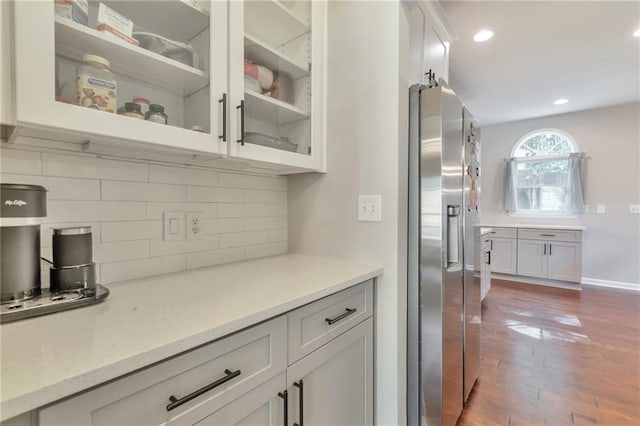 4360 Canterbury Walk Dr, Duluth, GA 30097 - kitchen with stainless steel refrigerator with ice dispenser, dark wood finished floors, tasteful backsplash, glass insert cabinets, and recessed lighting