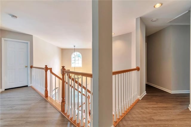 4360 Canterbury Walk Dr, Duluth, GA 30097 - hall featuring wood finished floors, baseboards, an upstairs landing, and attic access