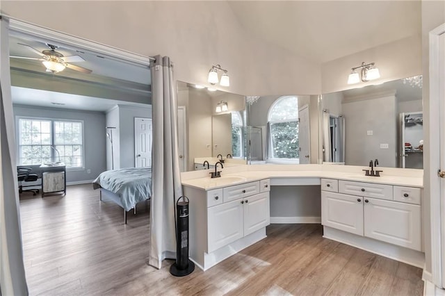 4360 Canterbury Walk Dr, Duluth, GA 30097 - ensuite bathroom featuring wood finished floors, vanity, a ceiling fan, lofted ceiling, and baseboards