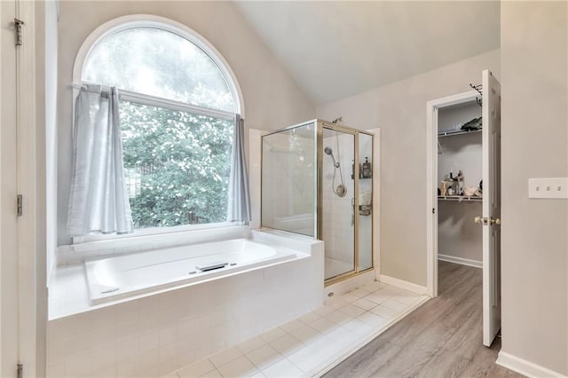 4360 Canterbury Walk Dr, Duluth, GA 30097 - full bath featuring a stall shower, a bath, a spacious closet, wood finished floors, and vaulted ceiling