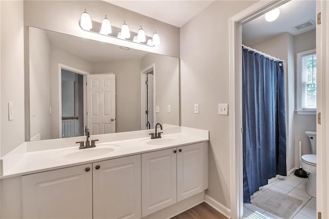 4360 Canterbury Walk Dr, Duluth, GA 30097 - bathroom featuring double vanity, toilet, baseboards, and tile patterned flooring