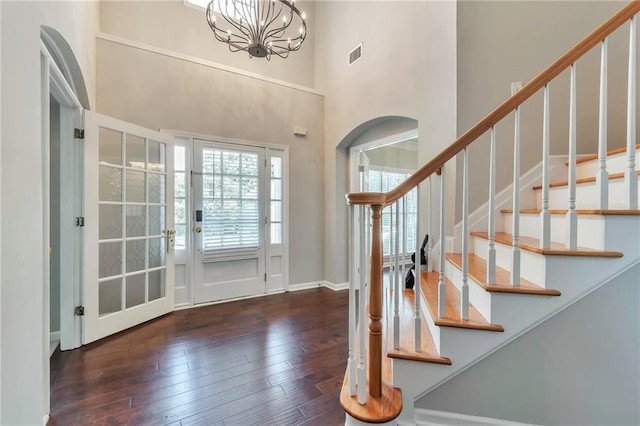 4360 Canterbury Walk Dr, Duluth, GA 30097 - entrance foyer with arched walkways, hardwood / wood-style floors, stairway, a chandelier, and a towering ceiling