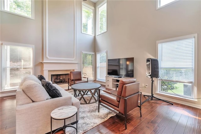 4360 Canterbury Walk Dr, Duluth, GA 30097 - living area with a towering ceiling, hardwood / wood-style flooring, a fireplace, and baseboards