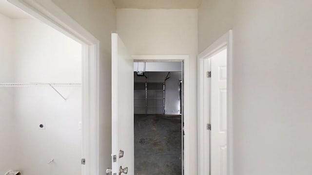 hall with unfinished concrete flooring