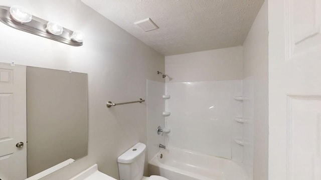 full bath featuring visible vents, toilet, a textured ceiling, and bathtub / shower combination