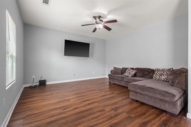 living room with a ceiling fan, dark wood-style floors, baseboards, and visible vents