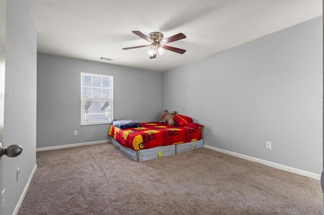 bedroom featuring baseboards, visible vents, carpet, and a ceiling fan