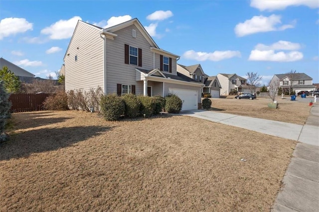 view of front of house featuring a residential view, fence, and concrete driveway