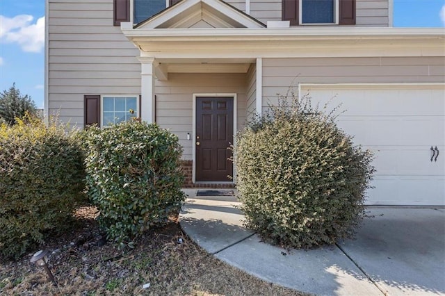 doorway to property with a garage