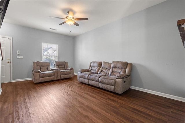 living room featuring baseboards, dark wood-style floors, and ceiling fan