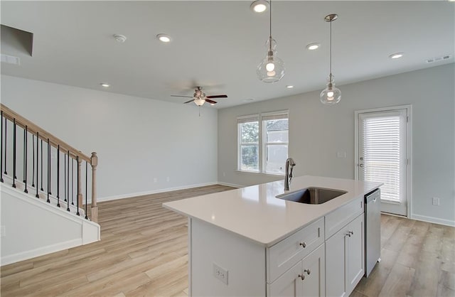 kitchen with dishwasher, visible vents, light wood-style floors, and a sink