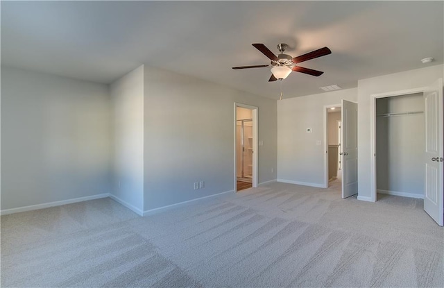 unfurnished bedroom with a closet, light colored carpet, visible vents, a ceiling fan, and baseboards