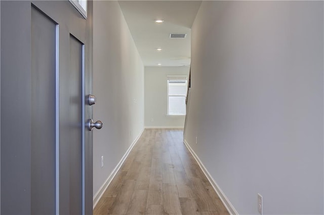 corridor with recessed lighting, visible vents, baseboards, and wood finished floors