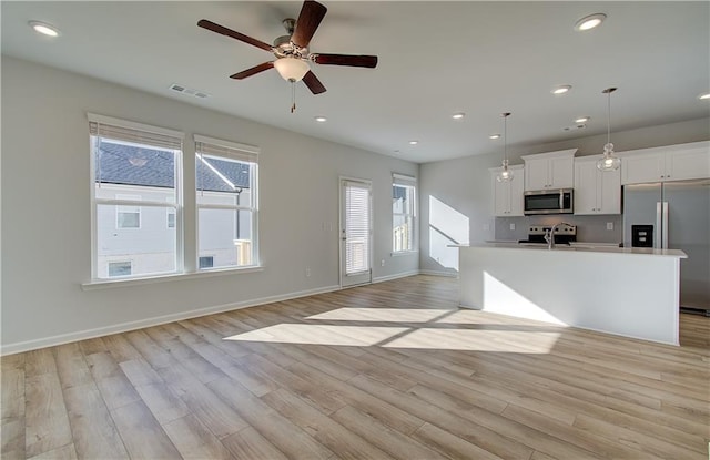 kitchen with stainless steel appliances, recessed lighting, visible vents, and light wood-style floors