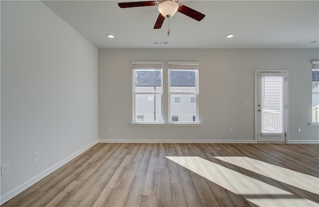 empty room with baseboards, recessed lighting, visible vents, and light wood-style floors