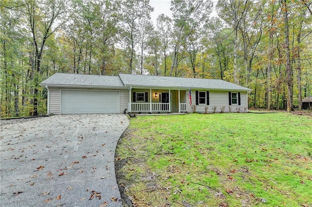 single story home with a garage, covered porch, and a front lawn