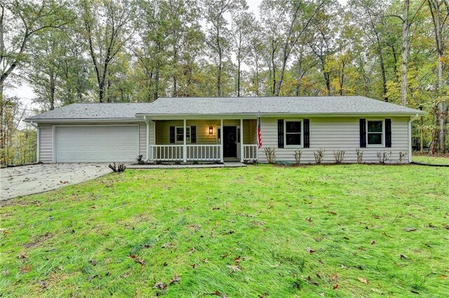 ranch-style house with a garage, covered porch, and a front lawn