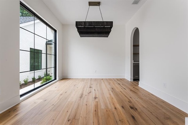 empty room with light hardwood / wood-style flooring