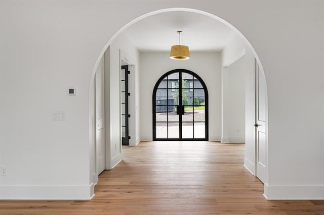 entrance foyer with french doors and light wood-type flooring