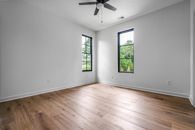 spare room featuring ceiling fan and light hardwood / wood-style flooring