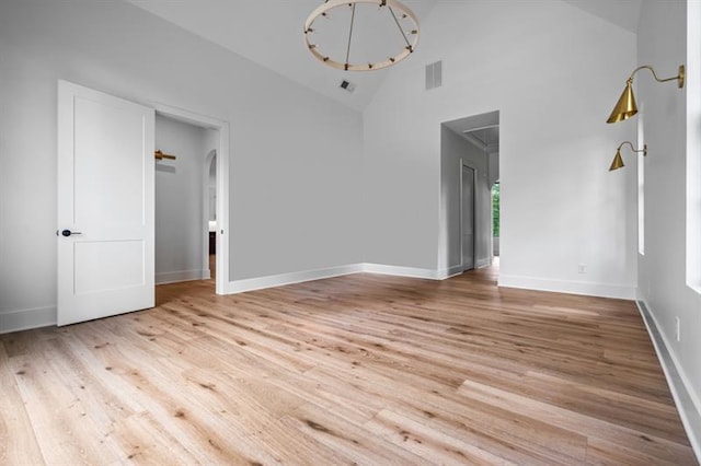 interior space featuring high vaulted ceiling and light hardwood / wood-style flooring