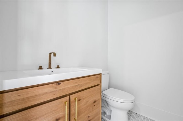 bathroom with tile patterned floors, vanity, and toilet