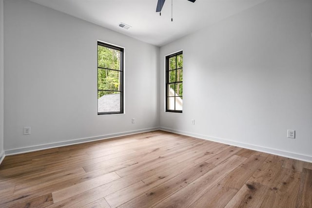 empty room with light wood-type flooring and ceiling fan