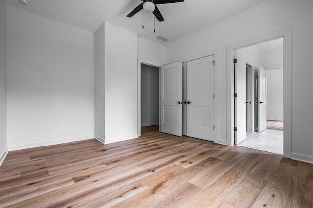 unfurnished bedroom with ceiling fan and light hardwood / wood-style floors