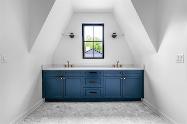 bathroom with vanity and vaulted ceiling