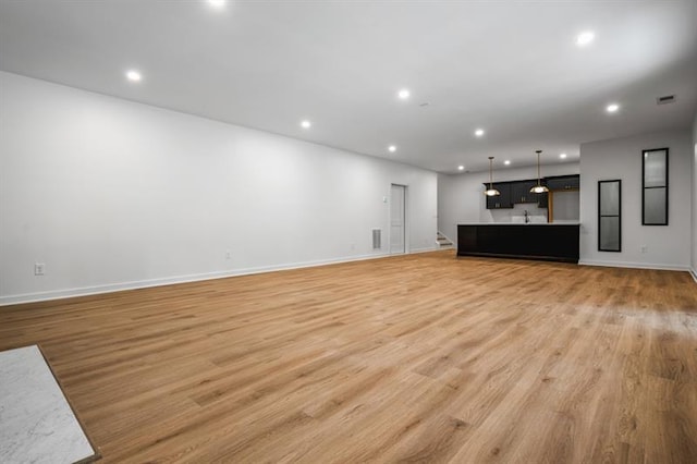 unfurnished living room featuring light wood-type flooring