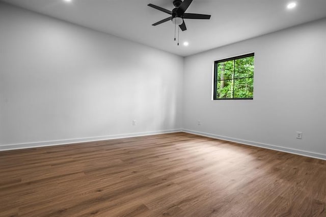 unfurnished room with ceiling fan and dark hardwood / wood-style floors