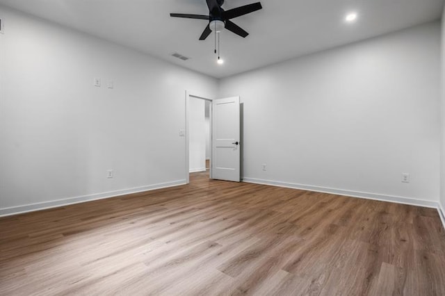 spare room with ceiling fan and light hardwood / wood-style floors