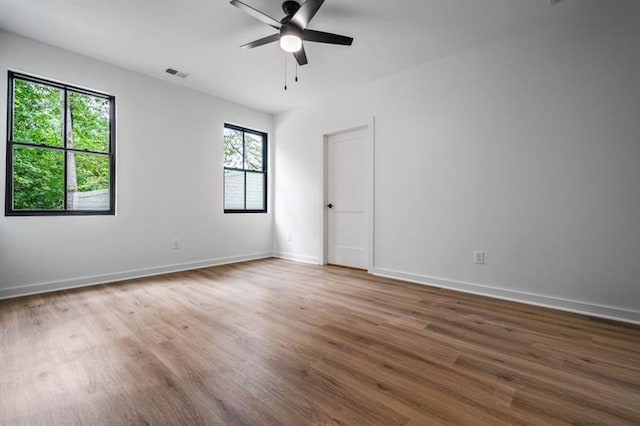 empty room featuring ceiling fan and dark hardwood / wood-style flooring