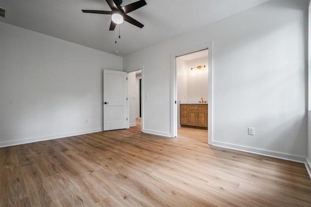 unfurnished bedroom with ceiling fan, light hardwood / wood-style floors, sink, and ensuite bath