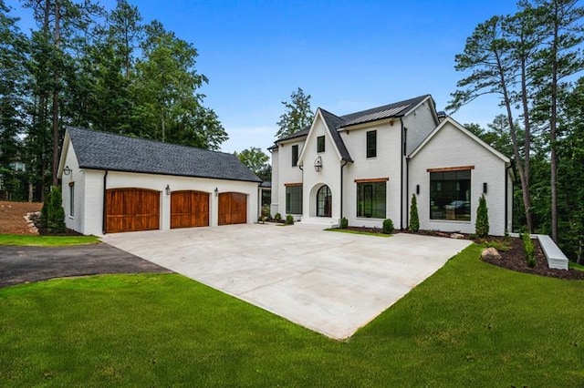 view of front facade with an outbuilding, a garage, and a front yard