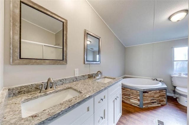 full bathroom with hardwood / wood-style flooring, toilet, ornamental molding, vaulted ceiling, and vanity